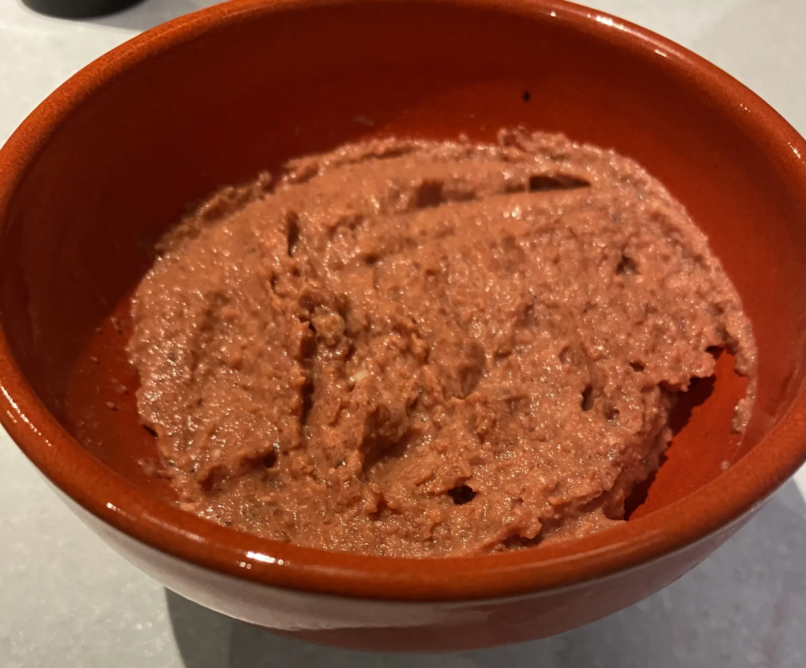 Bright pink roasted beetroot hummus in a serving bowl